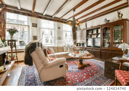 A beautifully designed living room featuring elegant furniture, traditional decor, and a warm atmosphere, perfect for relaxation and gatherings. 124814740