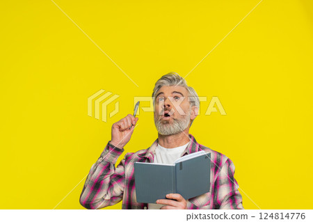 Mature man making notes writing thoughts with pen into notepad notebook diary to do list good idea Mature man making notes writing thoughts with pen into notepad notebook diary to do list good idea 124814776