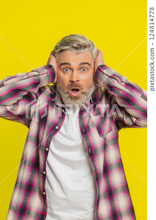 Mature man covering ears, intense fear gesture, startled panic from loud noise shocking reaction 124814778