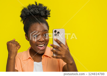 Happy excited winner woman use smartphone celebrating success winning play game good lottery news 124814780