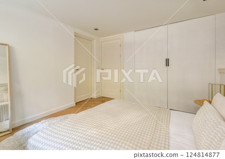 A serene and spacious modern bedroom featuring light colors, minimalist furniture, and ample natural light, creating a calming atmosphere for relaxation. A serene and spacious modern bedroom featuring light colors, minimalist furniture, and ample natural light, creating a calming atmosphere for relaxation. 124814877
