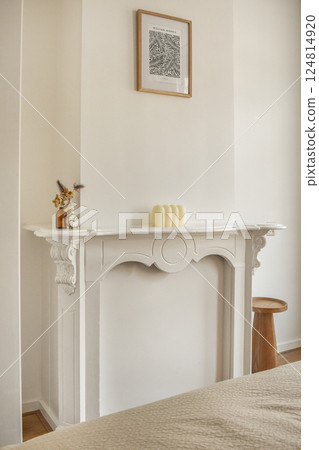 A stylish interior featuring a white fireplace, minimalist decor, and soft textures, creating a cozy yet contemporary ambiance for any living space. A stylish interior featuring a white fireplace, minimalist decor, and soft textures, creating a cozy yet contemporary ambiance for any living space. 124814920