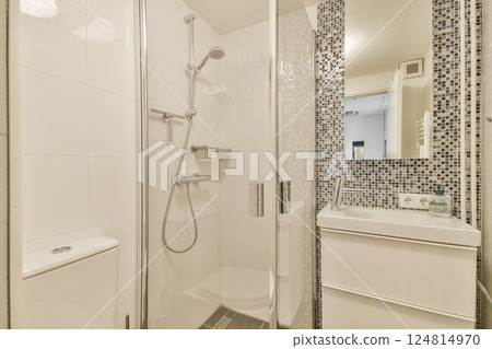 A sleek, modern bathroom showcasing a minimalist design with a walk-in shower, stylish tiles, and contemporary fixtures. A sleek, modern bathroom showcasing a minimalist design with a walk-in shower, stylish tiles, and contemporary fixtures. 124814970