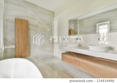 This contemporary bathroom features sleek designs, elegant fixtures, and a calming color palette, creating a serene and inviting atmosphere. 124814998