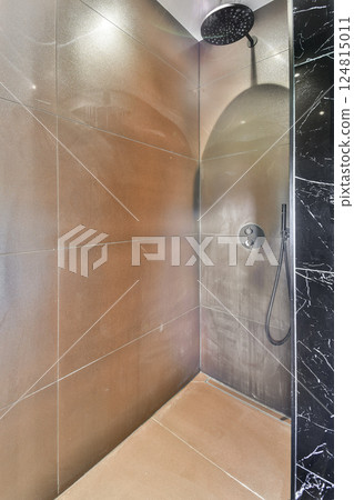 A sleek and contemporary shower space featuring elegant wall tiles and a minimalist design. Perfect for modern bathrooms with a focus on luxury and comfort. 124815011