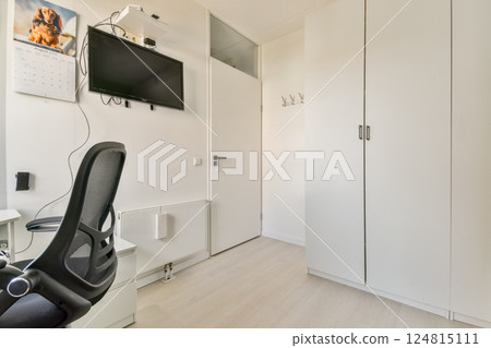 A clean and modern home office featuring a sleek desk, ergonomic chair, and minimal decor, promoting a focused work environment. A clean and modern home office featuring a sleek desk, ergonomic chair, and minimal decor, promoting a focused work environment. 124815111