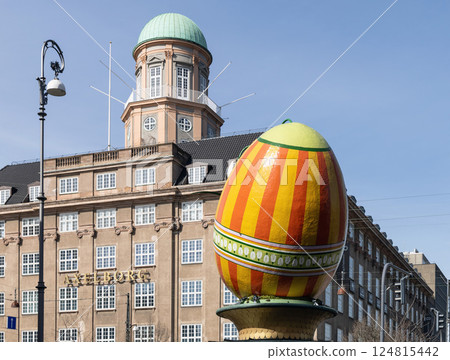 A large decorative Easter egg against a building in the city of Copenhagen 124815442