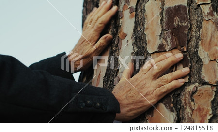Hands Of An Elderly Man Touches The Bark Of A Tree Trunk Hands Of An Elderly Man Touches The Bark Of A Tree Trunk 124815518