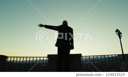 Silhouette Of A Man Looking Out From The Balcony And Happily Greeting The People 124815525