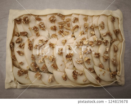 Rustic pear pastry with walnut topping, baked on golden flaky crust in traditional prague kitchen setting easy dinner for Valentines day Rustic pear pastry with walnut topping, baked on golden flaky crust in traditional prague kitchen setting easy dinner for Valentines day 124815678