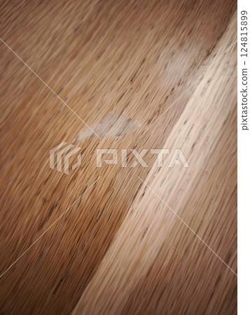 A spot without varnish on the table, damaging oak wood surface, showing home repair needs 124815899