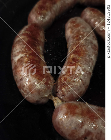 Close up of sausages sizzling on a black frying pan, cooking in chamonix, france, during november 124815902