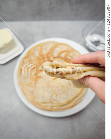 Chef folding a freshly made crepe for pancake day, shrove tuesday, maslenitsa or breakfast Chef folding a freshly made crepe for pancake day, shrove tuesday, maslenitsa or breakfast 124815907