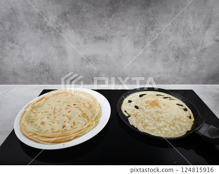 Cooking crepes for shrove tuesday or pancake day, maslenitsa or breakfast celebration in prague 124815916