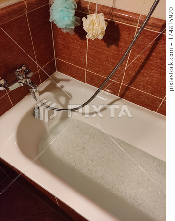 Water cascading into porcelain tub, generating soft bubbling foam for tranquil bathing moment spa valentine's day Water cascading into porcelain tub, generating soft bubbling foam for tranquil bathing moment spa valentine's day 124815920