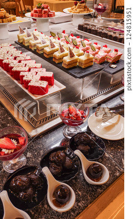 Delicious desserts displayed on buffet table tempting guests in marsa alam resort Delicious desserts displayed on buffet table tempting guests in marsa alam resort 124815951