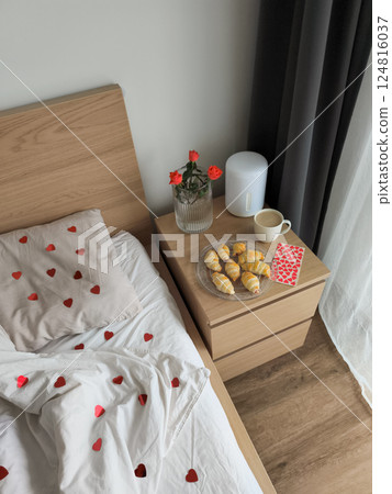 Romantic valentine's morning, plush bedding, heart decor, golden croissants, soft roses bedside table, breakfast Romantic valentine's morning, plush bedding, heart decor, golden croissants, soft roses bedside table, breakfast 124816037