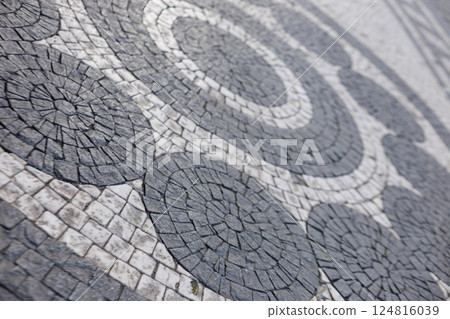 Cobblestone mosaic creating circular patterns on prague pavement 124816039