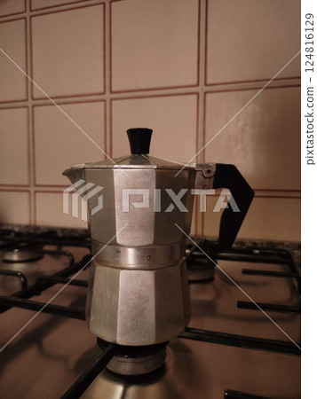 Classic italian coffee maker, known as a moka pot, brewing fresh coffee on a gas stovetop in a kitchen in bibione, italy 124816129