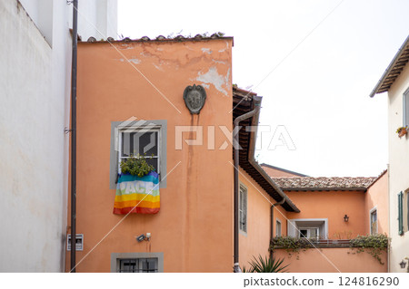 Rainbow flag hanging out of a window during the Pride festival Rainbow flag hanging out of a window during the Pride festival 124816290