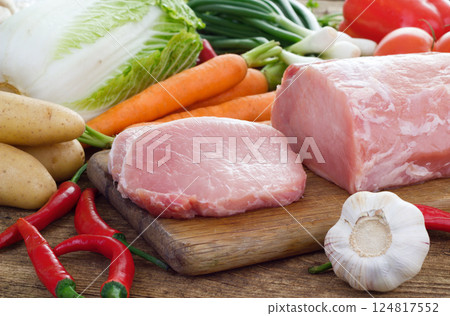 Vegetables and pork meat on cutting board 124817552