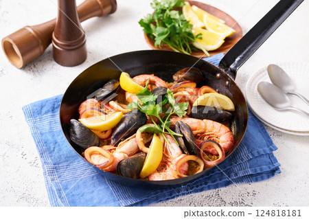 Paella made in a frying pan 124818181