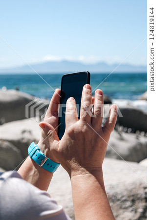 Female hands holding mobile phone and taking photos 124819144