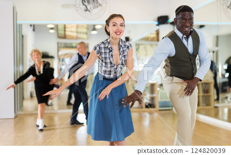 Woman and man dancing swing in studio Woman and man dancing swing in studio 124820039