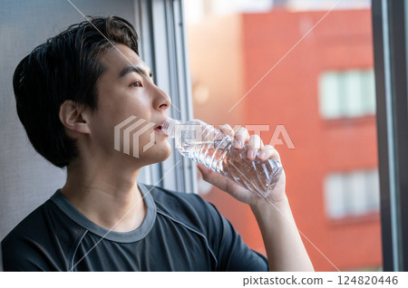 Man drinking water at the gym 124820446