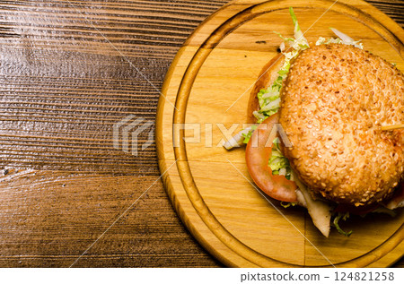 Bacon burger with beef patty on wooden table Bacon burger with beef patty on wooden table 124821258
