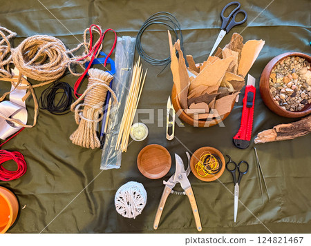 Tools and materials for creating ikebana art arranged on a work surface. Preparation, focus and the meditative process of floral design. Workshop concept 124821467