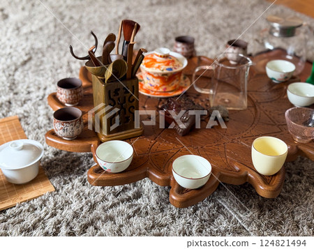 Vintage ceramic teapot and cups on linen with eucalyptus and moonstone jewelry. Tea ceremony and sensory aesthetics 124821494