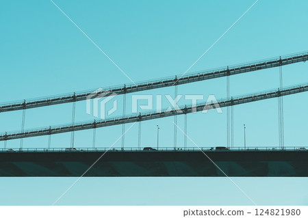 Suspension road bridge, urban highway, graphic lines, geometric design, bridge construction. Bridge silhouette background, bright sky, urban minimalism 124821980