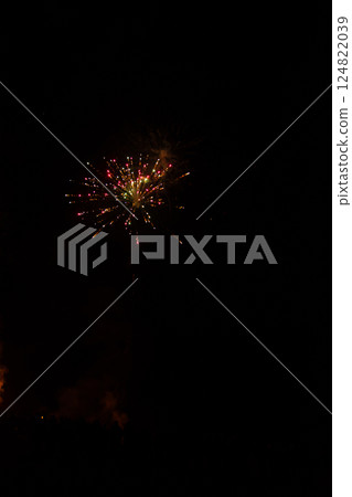 Colorful fireworks burst in the night sky over a picturesque landscape, celebrating a vibrant festival, bringing joy and excitement to onlookers below Colorful fireworks burst in the night sky over a picturesque landscape, celebrating a vibrant festival, bringing joy and excitement to onlookers below 124822039