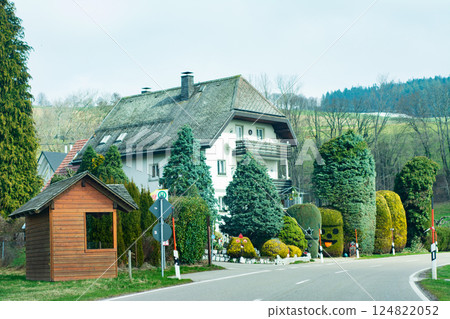 Charming countryside house surrounded by lush greenery and a winding road showcasing the beauty of rural life on a tranquil afternoon in the hills Charming countryside house surrounded by lush greenery and a winding road showcasing the beauty of rural life on a tranquil afternoon in the hills 124822052