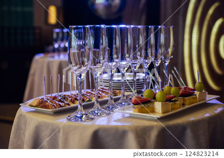 Appetizer Plate. An area for welcoming guests with food and empty champagne glasses Appetizer Plate. An area for welcoming guests with food and empty champagne glasses 124823214