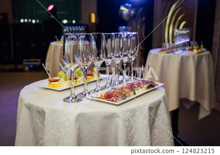 Appetizer Plate. An area for welcoming guests with food and empty champagne glasses Appetizer Plate. An area for welcoming guests with food and empty champagne glasses 124823215