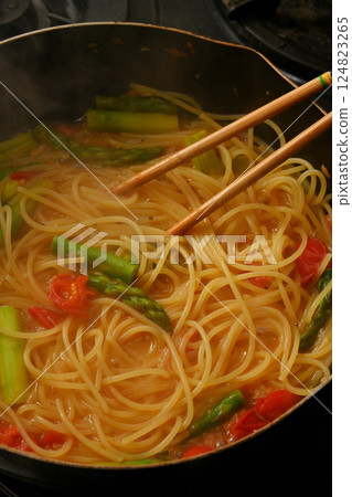 Cooking pasta with tomato sauce 124823265