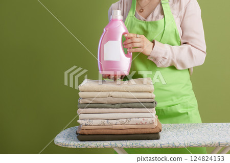 Woman presenting laundry detergent Woman presenting laundry detergent 124824153