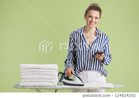 Multitasking: Ironing and tech Multitasking: Ironing and tech 124824202