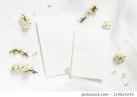 Blank cards near tulle and wild plums white flowers top view on white, boho wedding mockup Blank cards near tulle and wild plums white flowers top view on white, boho wedding mockup 124824243