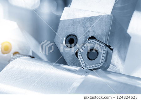 Close up scene the chip insert tool for CNC lathe machine in the light blue scene. Close up scene the chip insert tool for CNC lathe machine in the light blue scene. 124824625