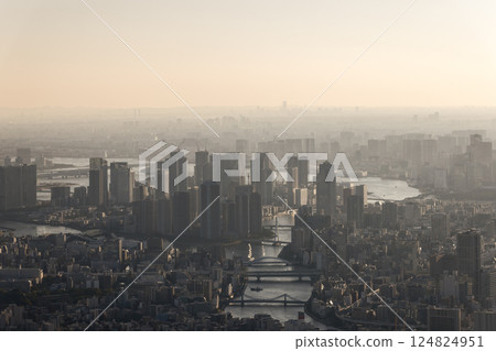 Panoramic shot of Tokyo at dusk, where high rise buildings and bridges emerge through the mist 124824951