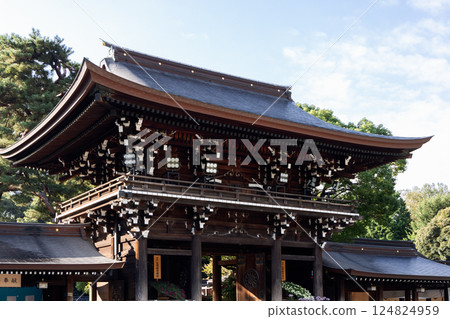 Grand entrance gate at Meiji Shrine in Tokyo features a sweeping tiled roof 124824959