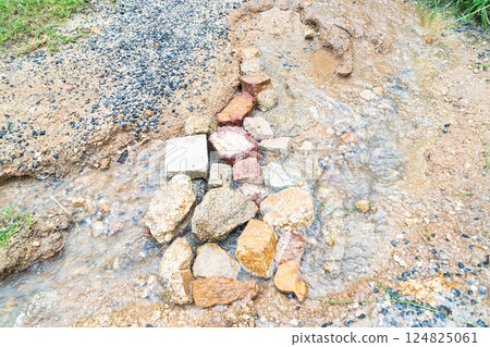 Water flows gently over smooth rocks, highlighting the beauty of nature's vibrant textures. Water flows gently over smooth rocks, highlighting the beauty of nature's vibrant textures. 124825061