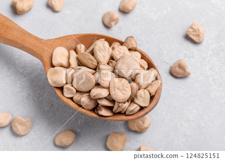 Organic dry Grass pea close up on wooden spoon 124825151