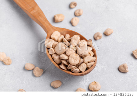 Organic dry Grass pea close up on wooden spoon 124825153