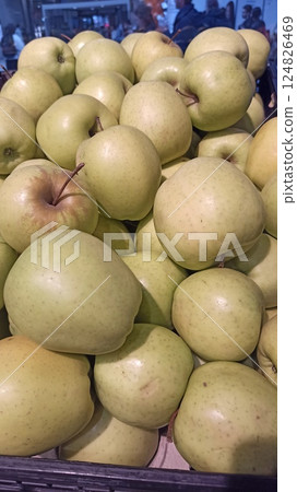 Fresh green apples stacked in a market 124826469