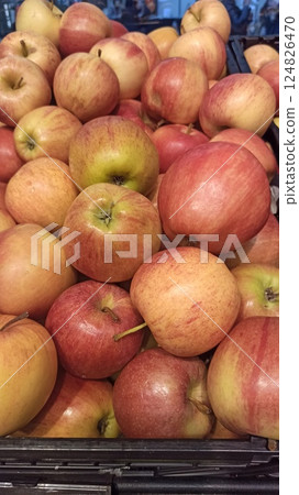 Fresh red apples piled in a display crate 124826470