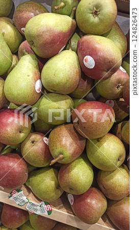 Fresh pears displayed in a wooden crate at market 124826473